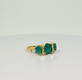 Ring with 3 green stones emeralds and diamonds. 