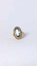 Ring with oval blue stone