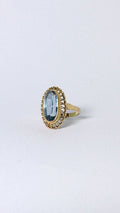 Ring with oval blue stone