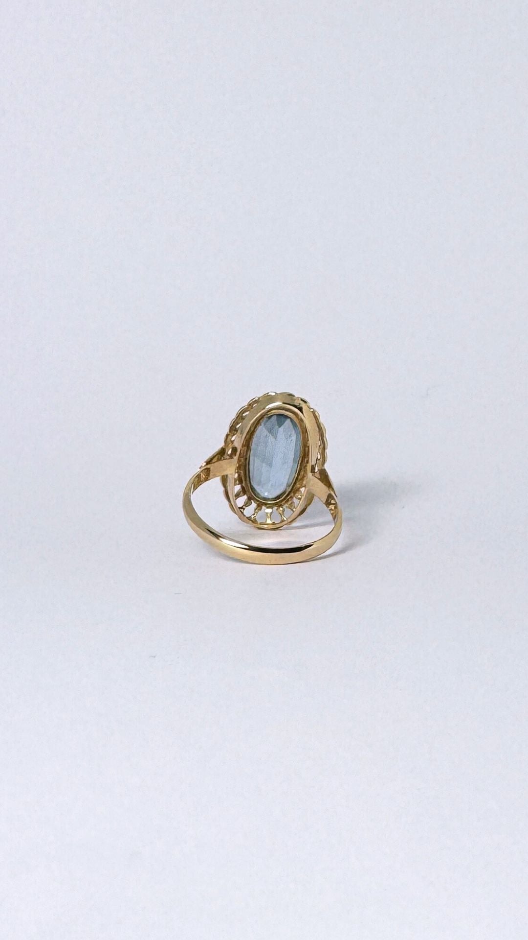 Ring with oval blue stone