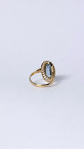 Ring with oval blue stone