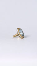 Ring with oval blue stone