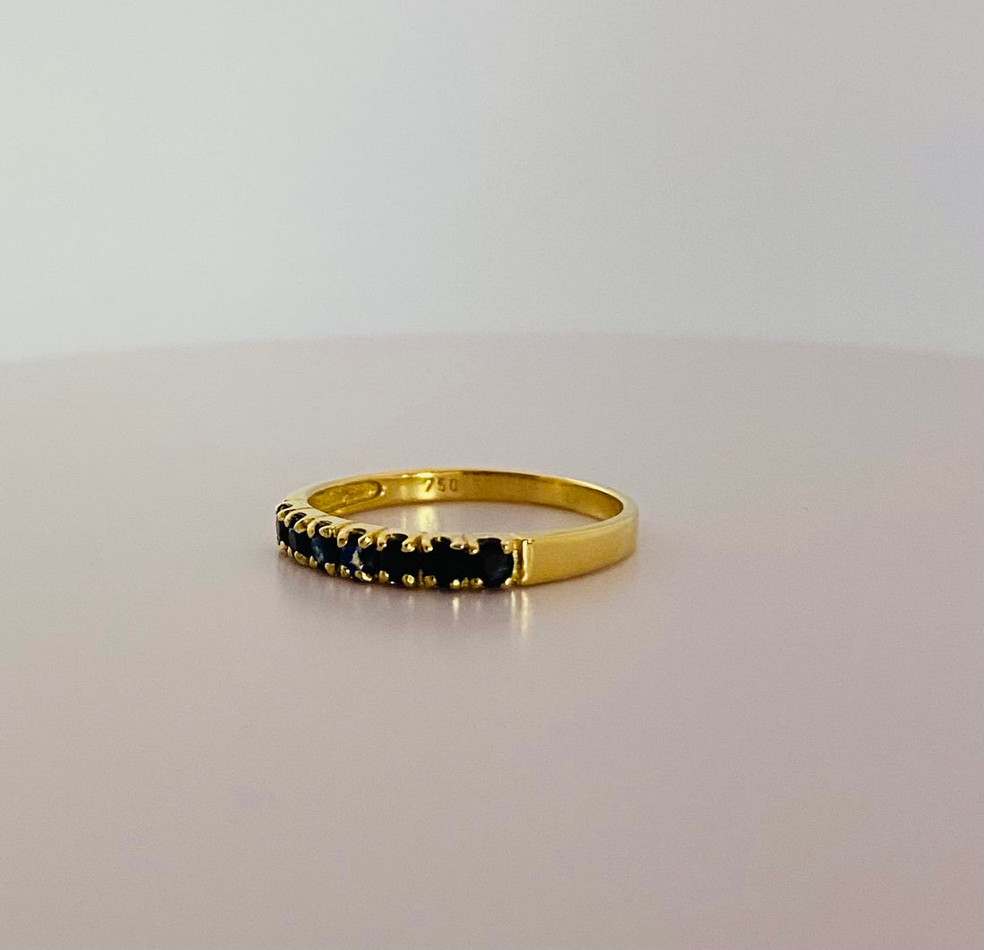 Row ring with dark blue stones