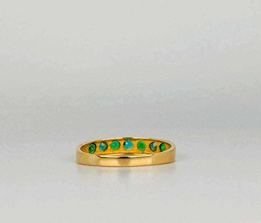 Ring with green stones from behind