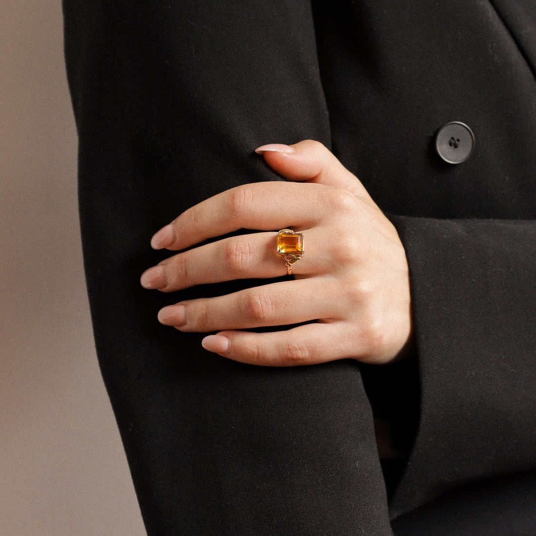 Ring with citrine yellow stone on finger on hand