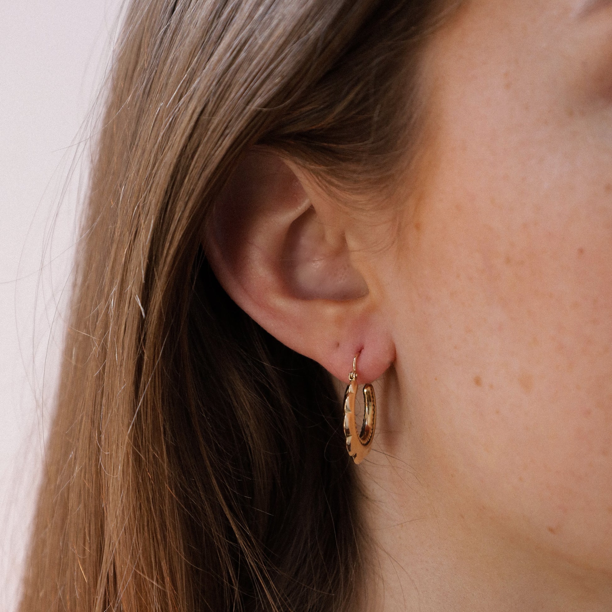 Vintage hoop earrings on ear